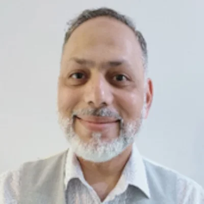 Portrait of a man with a beard smiling.